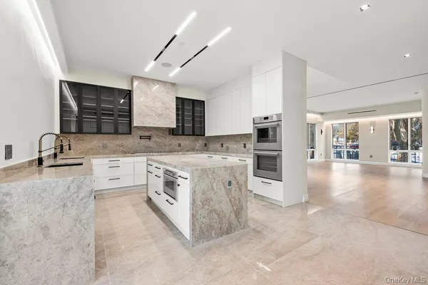 a kitchen with stainless steel appliances granite countertop a stove sink and cabinets