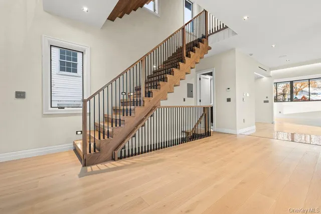 a view of a hallway with wooden floor and entryway