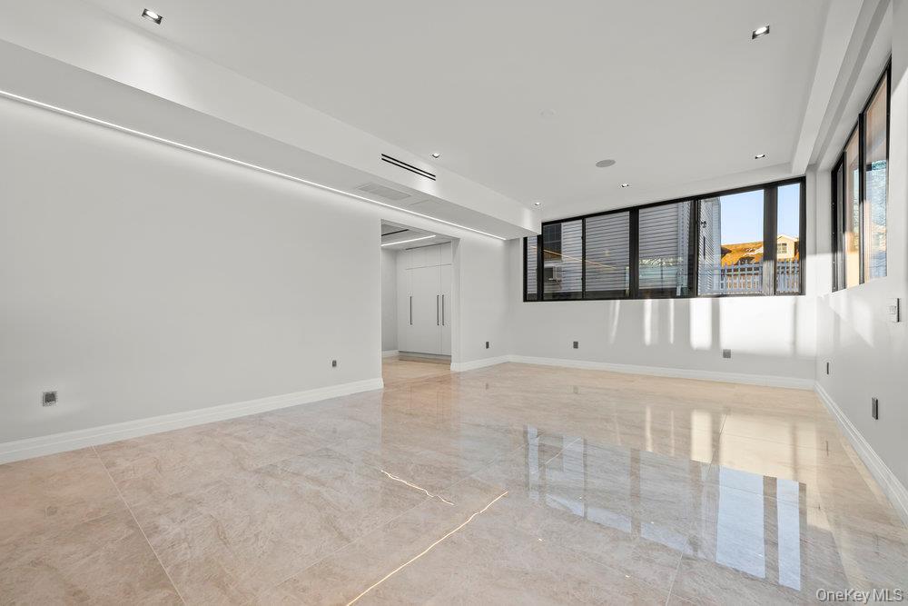 176-12 Kildare Road Queens, NY 11432 - Photo 10 of 34 Spare room featuring light marble finish floors and recessed lighting