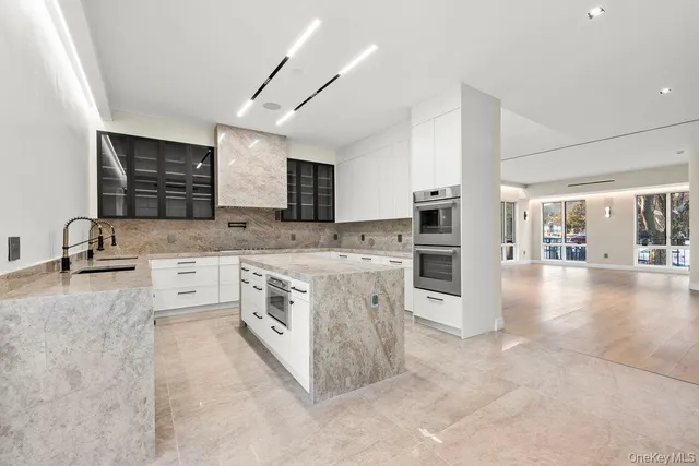 a kitchen with stainless steel appliances granite countertop a stove sink and cabinets