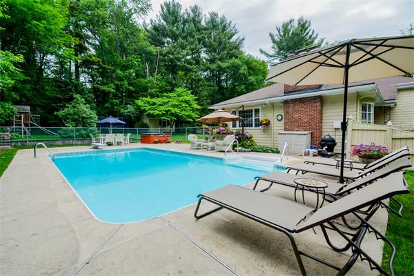 48 Prospect Road Andover, MA 01810 - Photo 20 of 23 a view of a white house with a patio and a slide