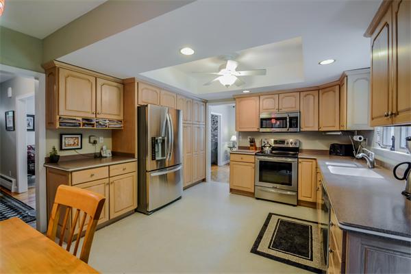 48 Prospect Road Andover, MA 01810 - Photo 4 of 23 a kitchen with kitchen island granite countertop a stove sink cabinets and refrigerator