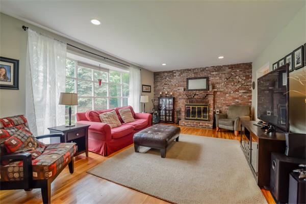 48 Prospect Road Andover, MA 01810 - Photo 6 of 23 a living room with furniture a flat screen tv and a fireplace