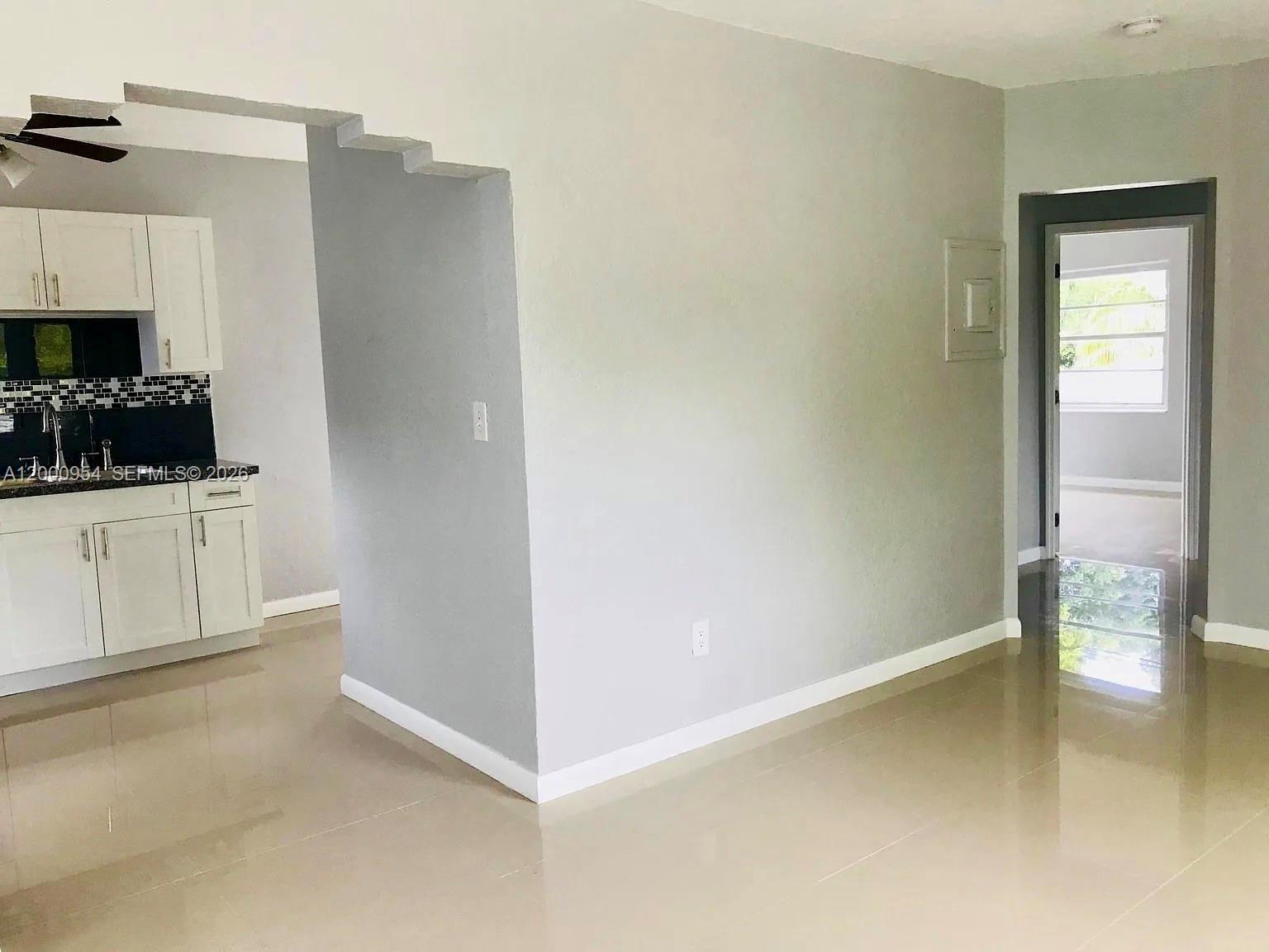 535 Northeast 68th Street, Unit UPSTAIRS Miami, FL 33138 - Photo 5 of 14 a kitchen with white cabinets and appliances
