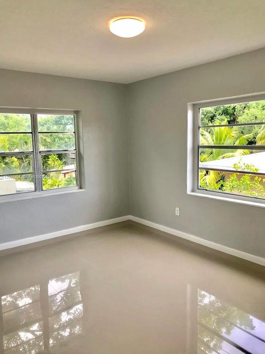 535 Northeast 68th Street, Unit UPSTAIRS Miami, FL 33138 - Photo 6 of 14 a view of an empty room with a window