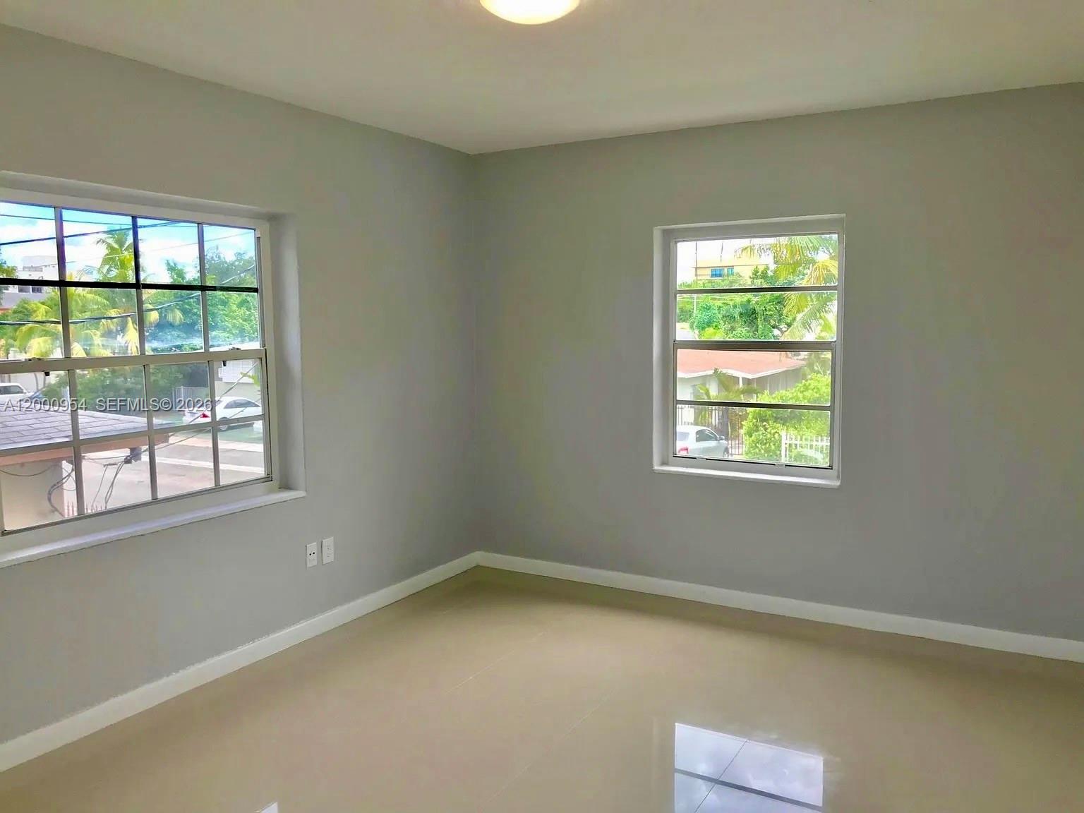 535 Northeast 68th Street, Unit UPSTAIRS Miami, FL 33138 - Photo 7 of 14 an empty room with a window