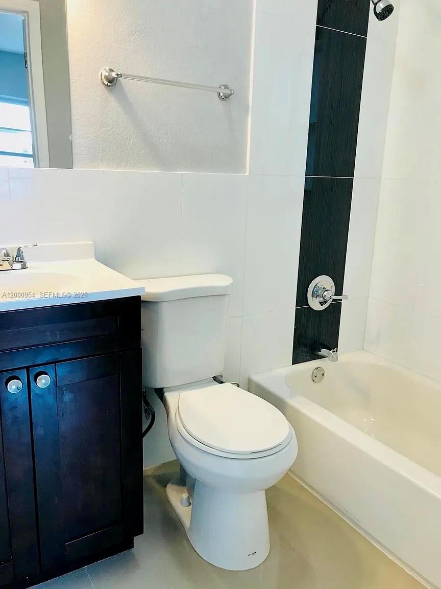 535 Northeast 68th Street, Unit UPSTAIRS Miami, FL 33138 - Photo 8 of 14 a bathroom with a sink toilet and shower
