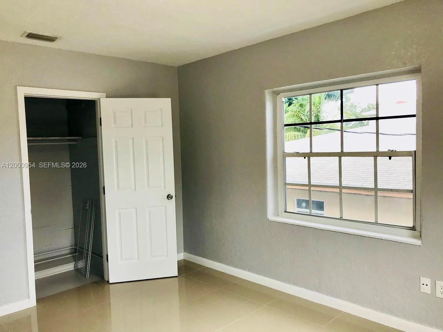 535 Northeast 68th Street, Unit UPSTAIRS Miami, FL 33138 - Photo 10 of 14 an empty room with windows