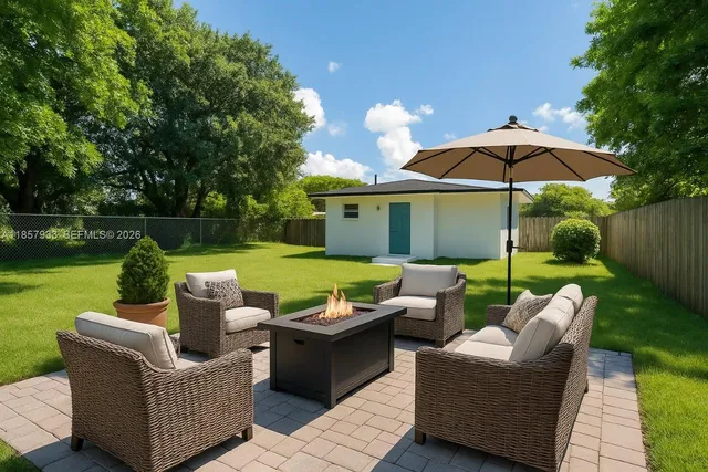 a view of a patio with couches chairs and a yard