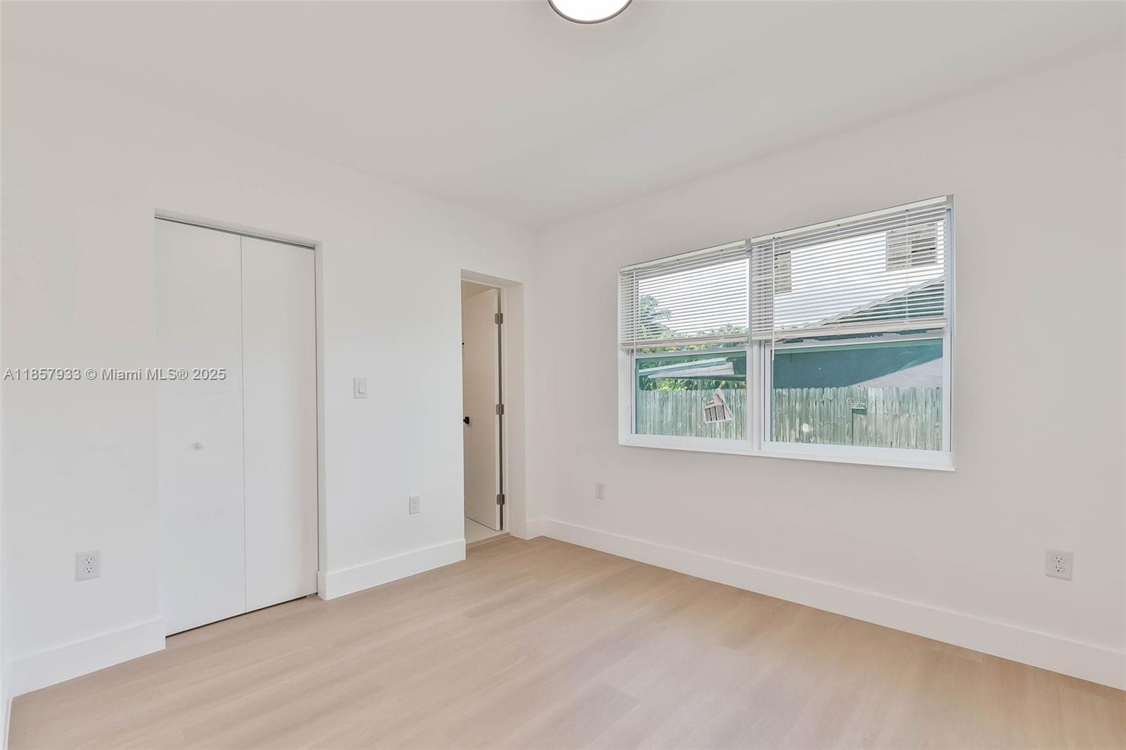 1366 Northwest 75th Street Miami, FL 33147 - Photo 20 of 26 an empty room with a window