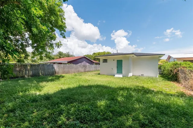 a view of a house with a yard and a garden