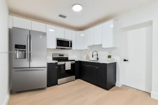 a kitchen with a refrigerator and a sink