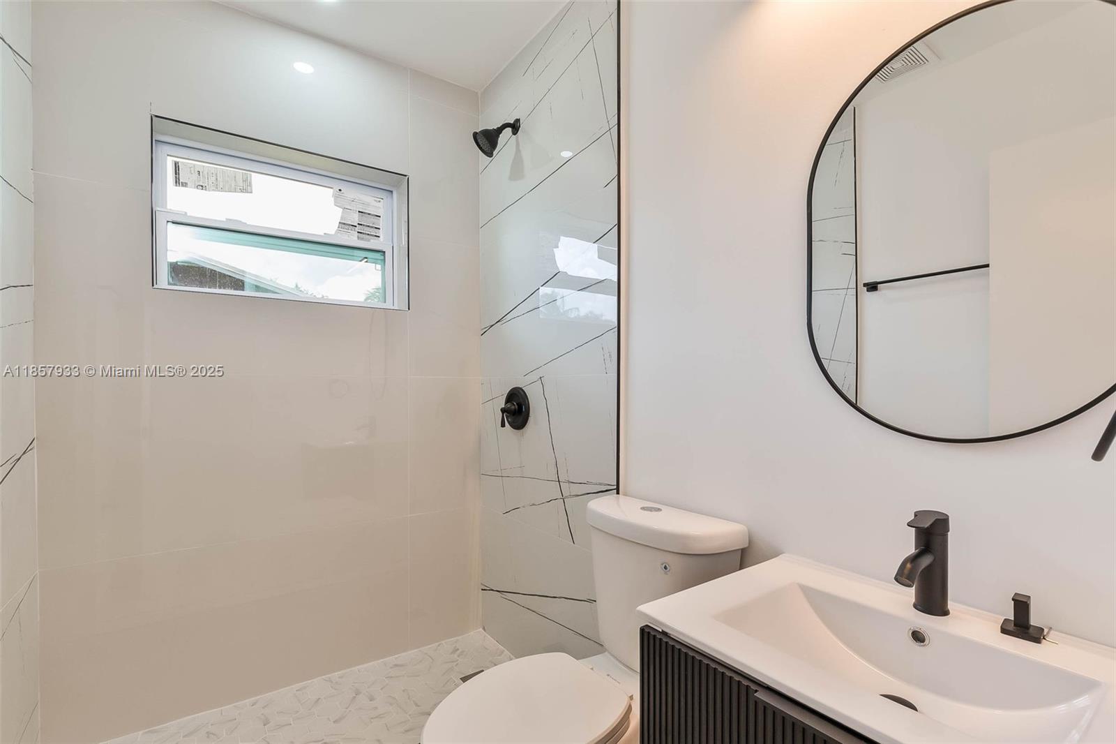 1366 Northwest 75th Street Miami, FL 33147 - Photo 7 of 26 a bathroom with a sink mirror and toilet