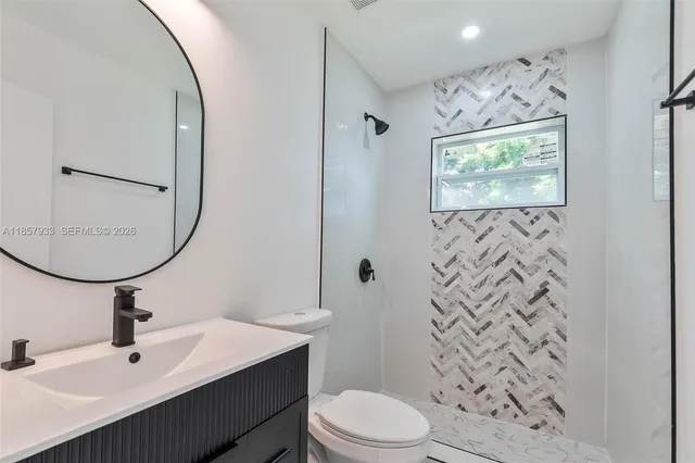 a bathroom with a sink toilet and mirror
