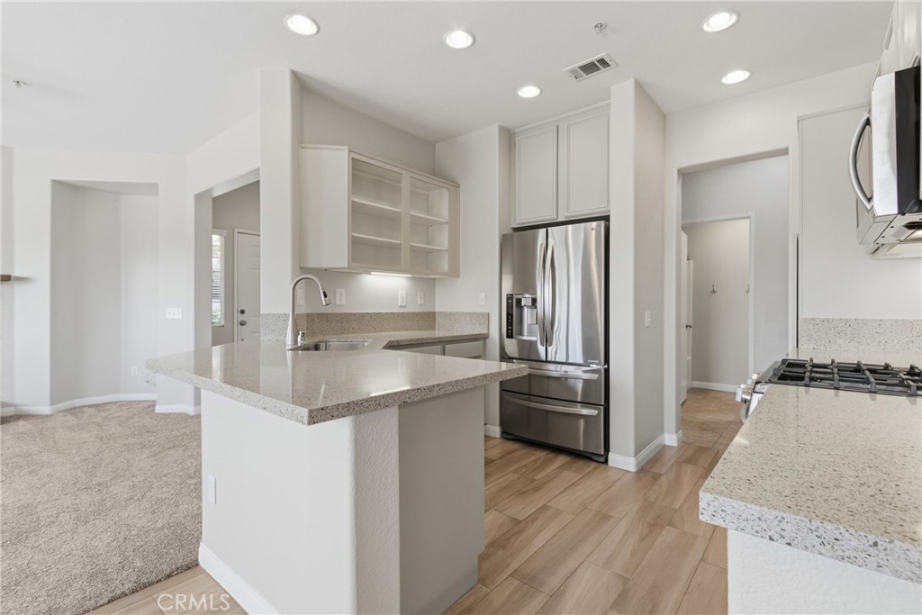 33576 Winston Way, Unit A Temecula, CA 92592 - Photo 11 of 44 a kitchen with stainless steel appliances granite countertop a refrigerator and a sink