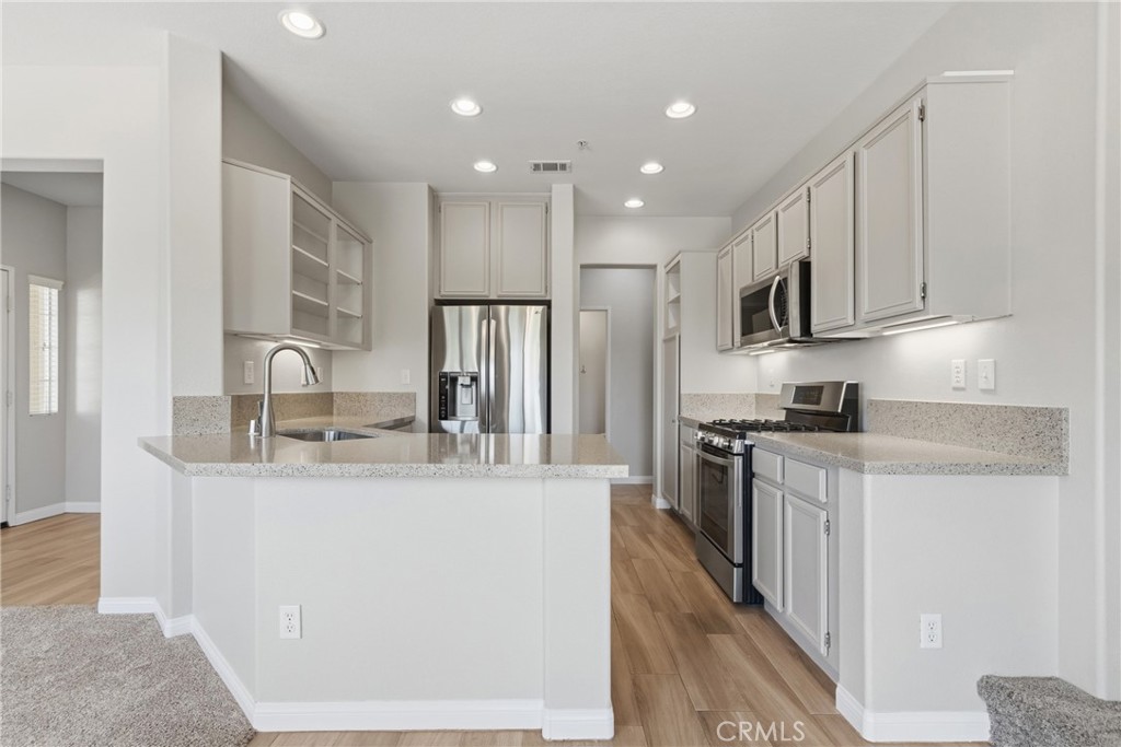33576 Winston Way, Unit A Temecula, CA 92592 - Photo 12 of 44 a kitchen with stainless steel appliances granite countertop a sink stove and refrigerator