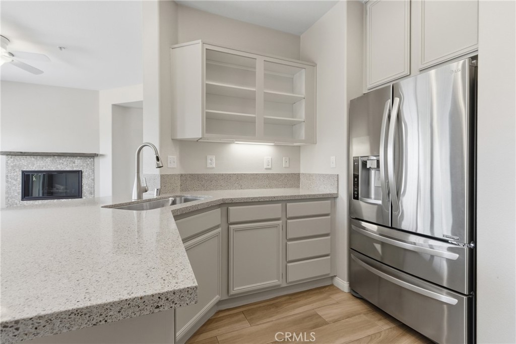 33576 Winston Way, Unit A Temecula, CA 92592 - Photo 13 of 44 a kitchen with kitchen island a counter top space cabinets and stainless steel appliances