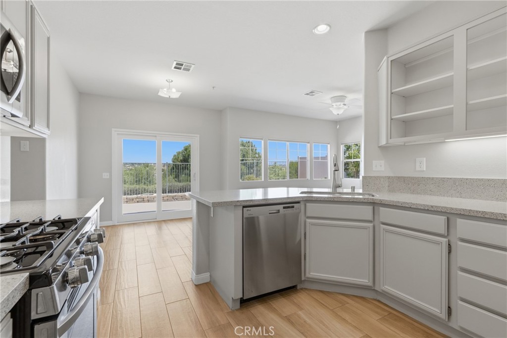 33576 Winston Way, Unit A Temecula, CA 92592 - Photo 14 of 44 a kitchen with stainless steel appliances granite countertop a stove and a sink