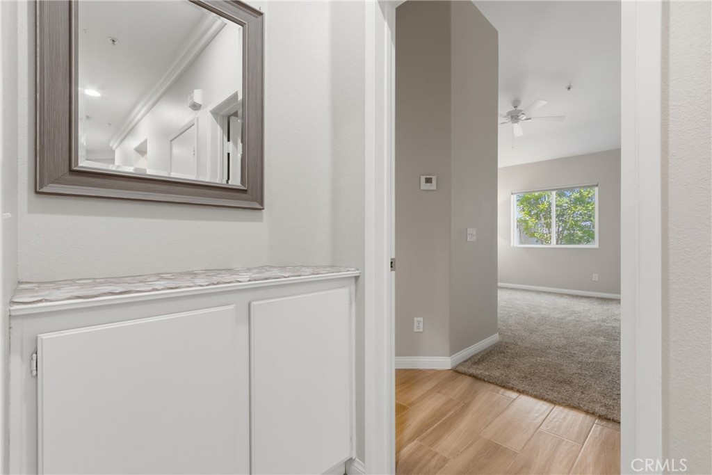 33576 Winston Way, Unit A Temecula, CA 92592 - Photo 17 of 44 a view of a hallway with wooden floor and a cabinet