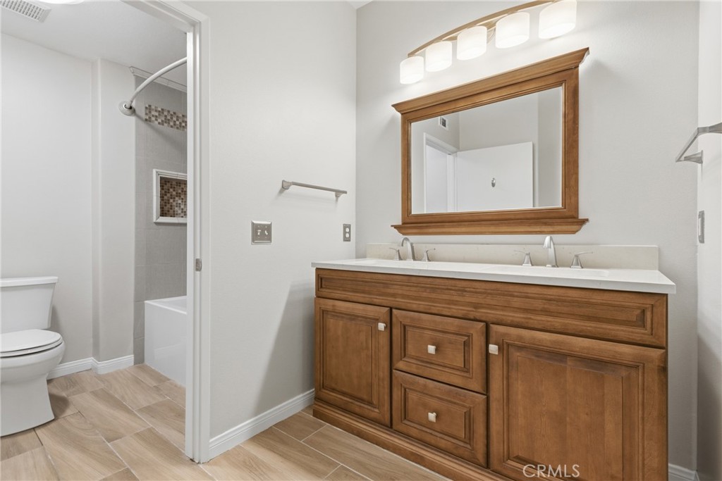 33576 Winston Way, Unit A Temecula, CA 92592 - Photo 22 of 44 a bathroom with a toilet sink and mirror
