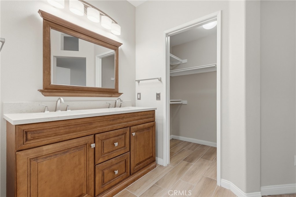 33576 Winston Way, Unit A Temecula, CA 92592 - Photo 23 of 44 a spacious bathroom with a double vanity sink and a mirror