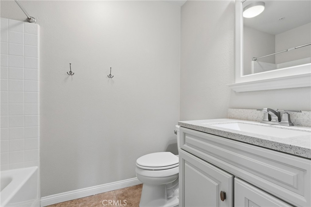 33576 Winston Way, Unit A Temecula, CA 92592 - Photo 26 of 44 a bathroom with a granite countertop toilet and a sink