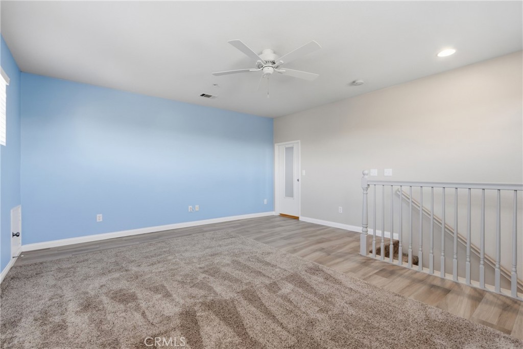 33576 Winston Way, Unit A Temecula, CA 92592 - Photo 29 of 44 an empty room with a ceiling fan and window