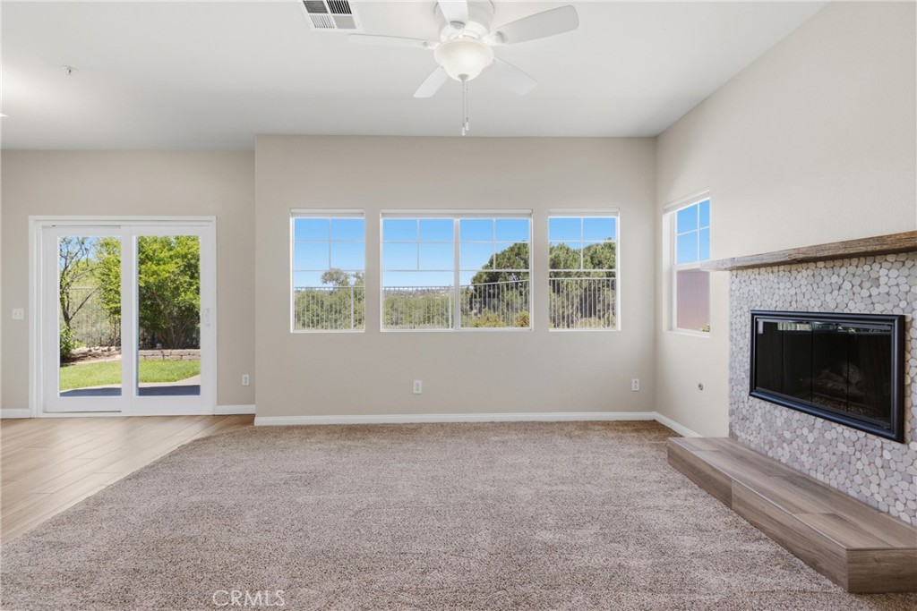 33576 Winston Way, Unit A Temecula, CA 92592 - Photo 4 of 44 an empty room with windows and fireplace