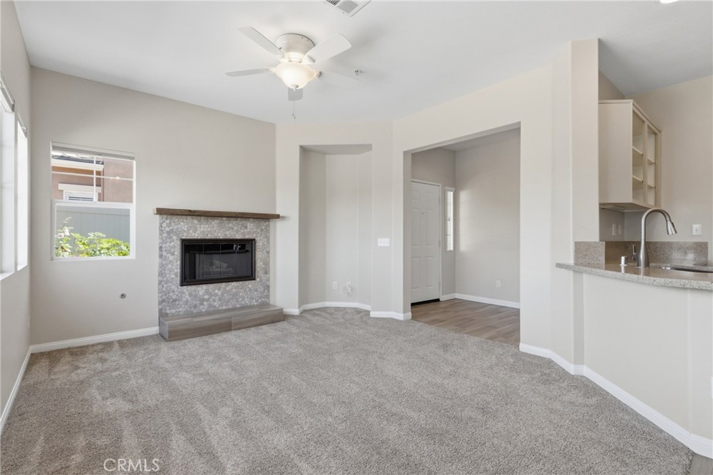 33576 Winston Way, Unit A Temecula, CA 92592 - Photo 6 of 44 a view of an empty room with a fireplace and a window