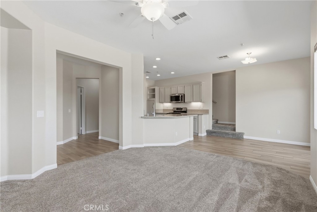 33576 Winston Way, Unit A Temecula, CA 92592 - Photo 7 of 44 a view of a kitchen with kitchen island a sink stainless steel appliances and cabinets