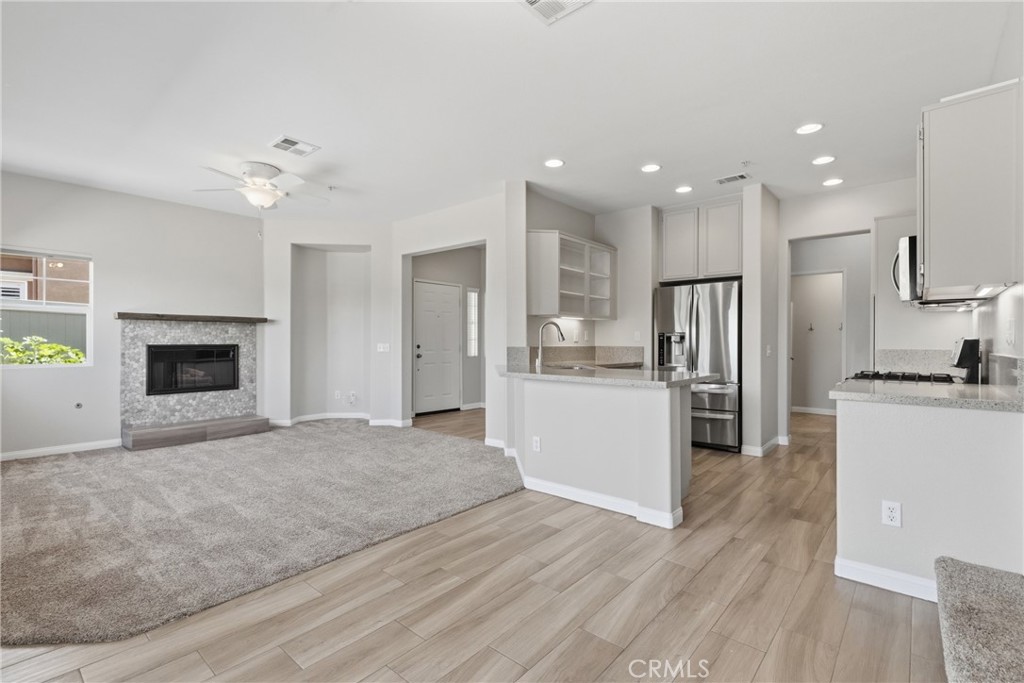 33576 Winston Way, Unit A Temecula, CA 92592 - Photo 8 of 44 a view of kitchen with refrigerator microwave and stove top oven