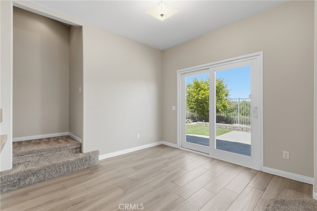 33576 Winston Way, Unit A Temecula, CA 92592 - Photo 9 of 44 an empty room with wooden floor and windows