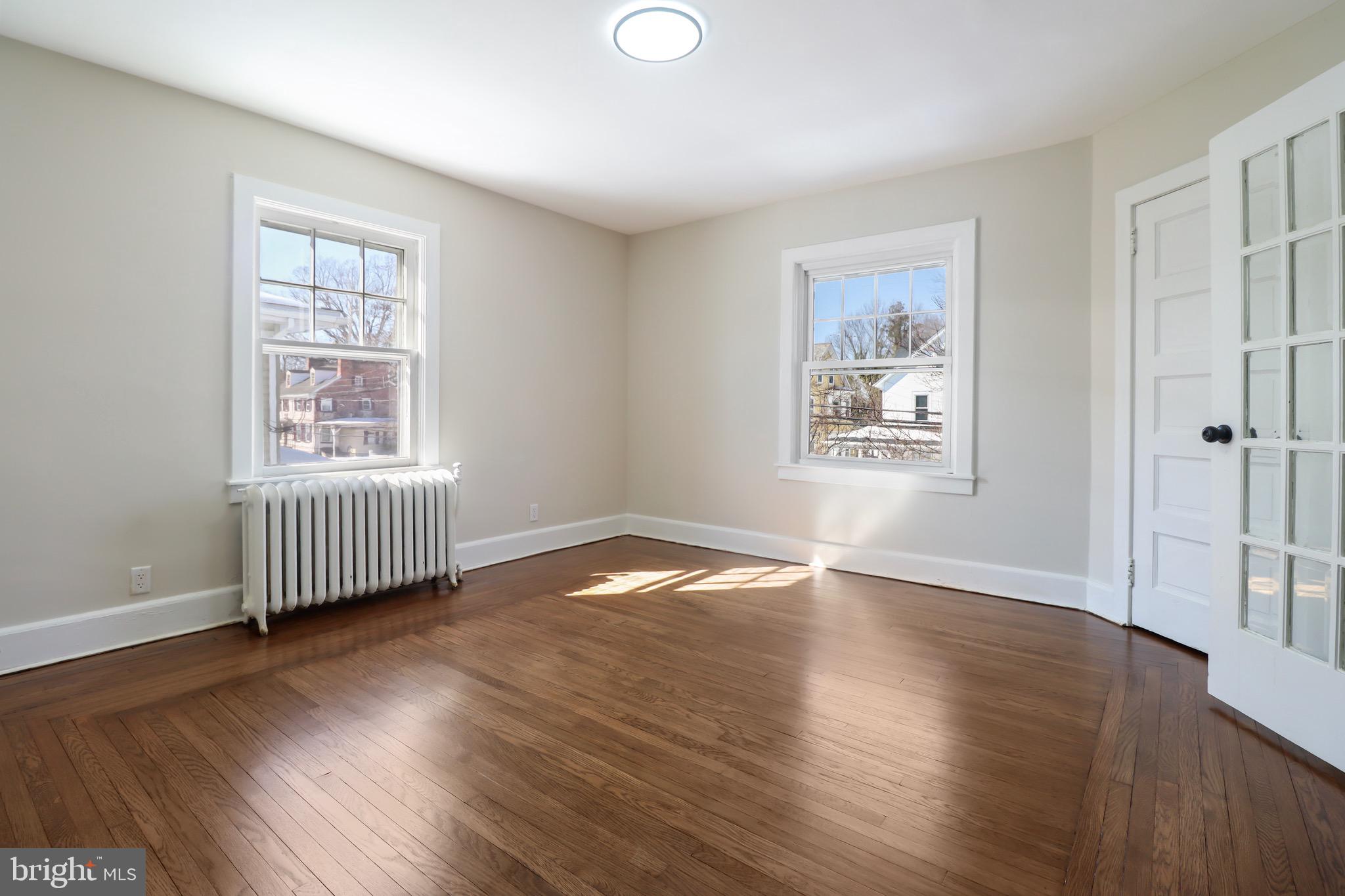 220 Johnson Street Salem, NJ 08079 - Photo 11 of 18 an empty room with wooden floor and windows