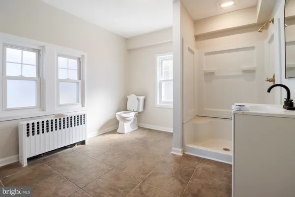 a view of a room with white walls and front door