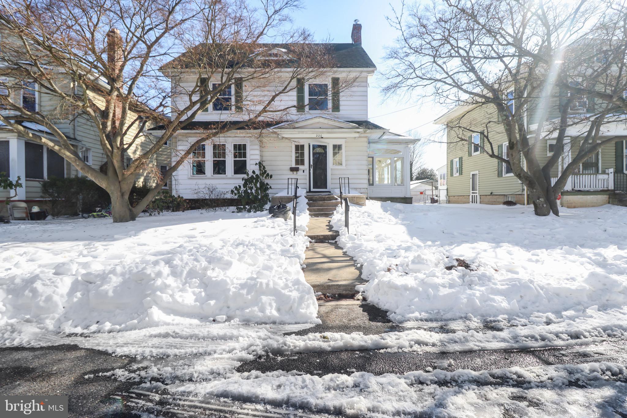 220 Johnson Street Salem, NJ 08079 - Photo 16 of 18 a front view of a house with a yard covered in snow