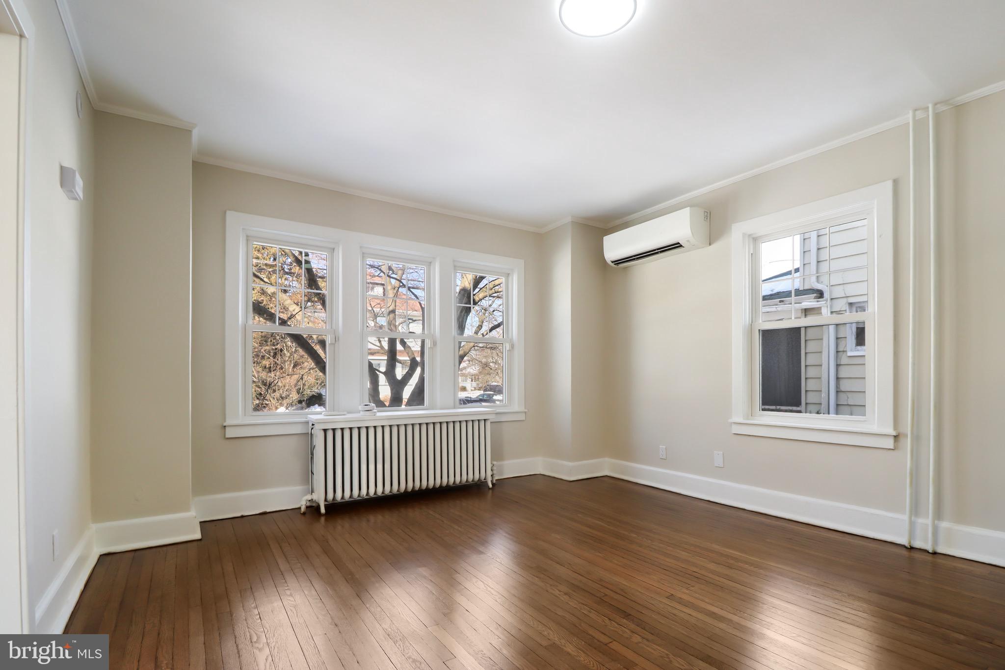 220 Johnson Street Salem, NJ 08079 - Photo 2 of 18 an empty room with wooden floor and windows