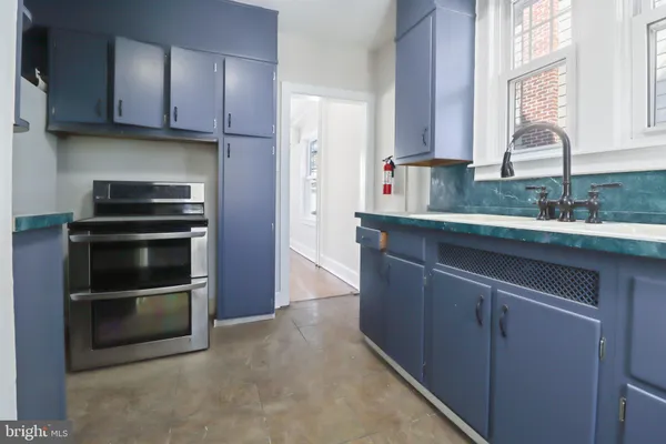 a kitchen with a sink and stainless steel appliances