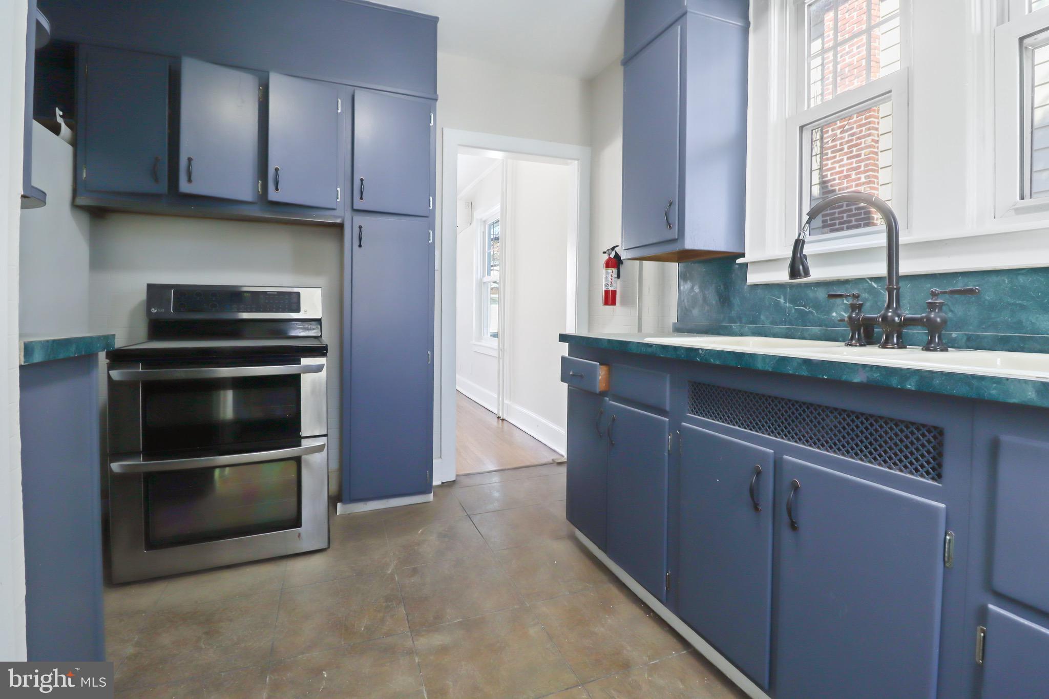 220 Johnson Street Salem, NJ 08079 - Photo 5 of 18 a kitchen with a sink and stainless steel appliances