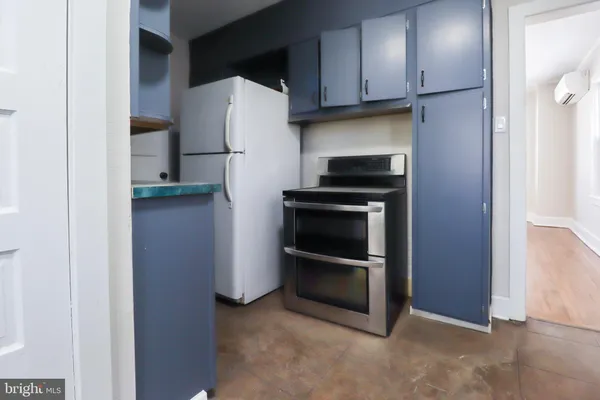 a kitchen with a refrigerator and a stove