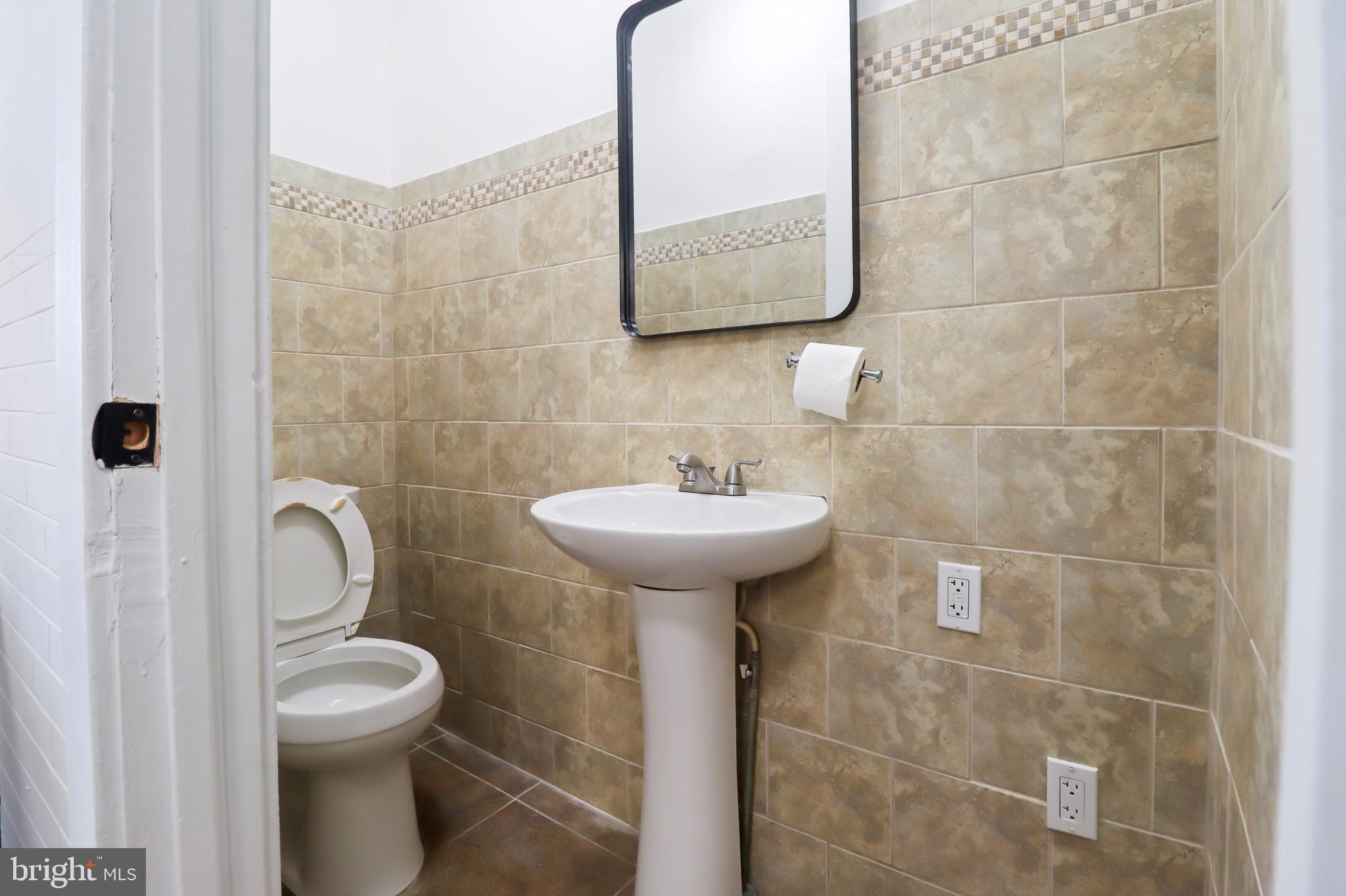 220 Johnson Street Salem, NJ 08079 - Photo 7 of 18 a bathroom with a sink toilet and a mirror