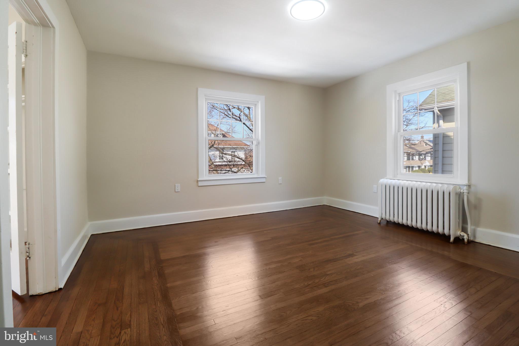 220 Johnson Street Salem, NJ 08079 - Photo 10 of 18 a view of an empty room with wooden floor and a window