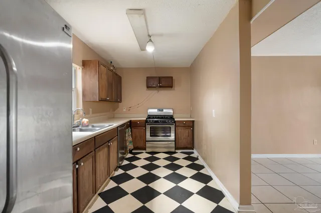 a stove top oven sitting inside of a kitchen