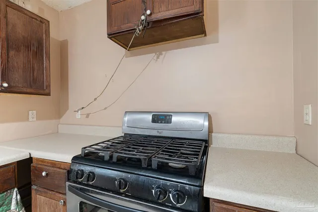 a bedroom with a bed flat screen tv and a large window