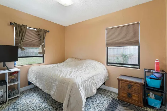 a living room with furniture and a workspace
