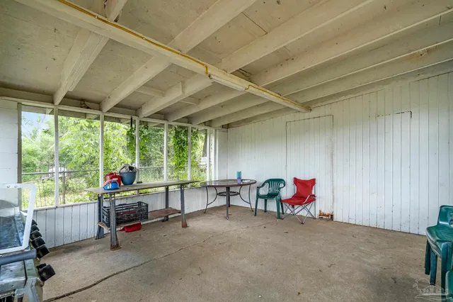 a backyard of a house with table and chairs