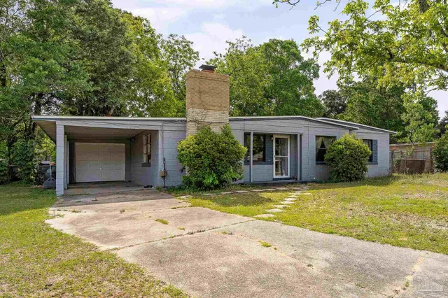 a view of a house with pool and a yard