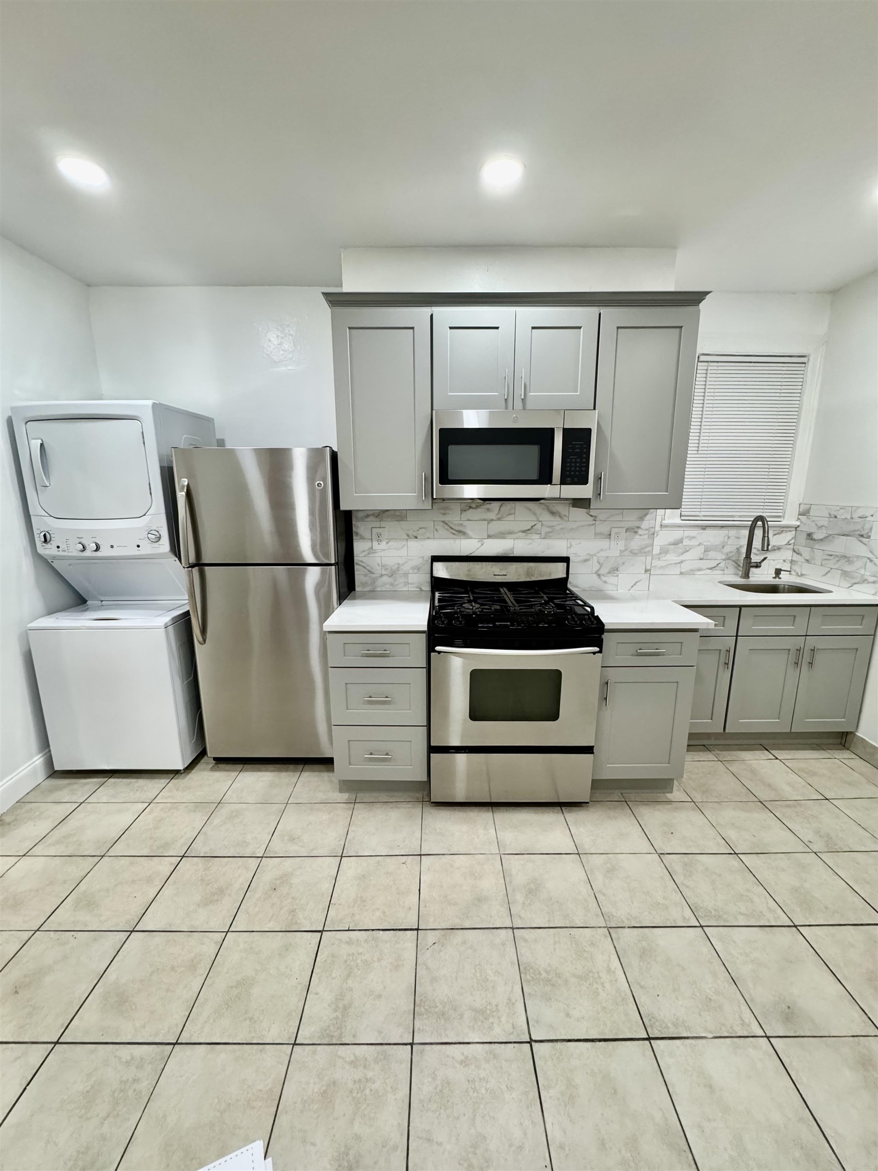 204 Zabriskie Street, Unit 1 & G Jersey City, NJ 07307 - Photo 1 of 21 a kitchen with stainless steel appliances a stove a sink and a refrigerator