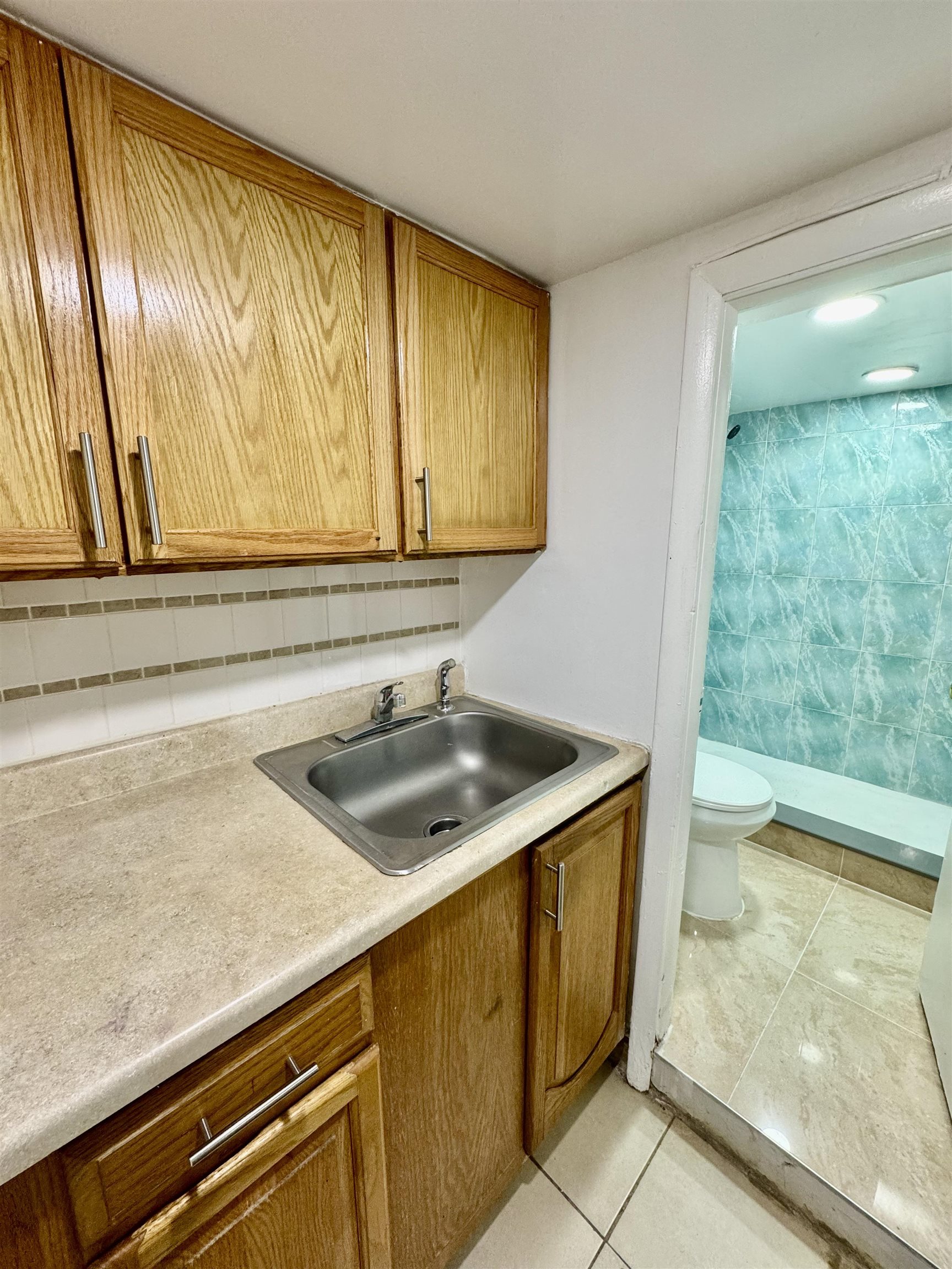 204 Zabriskie Street, Unit 1 & G Jersey City, NJ 07307 - Photo 17 of 21 a kitchen with stainless steel appliances granite countertop a sink and a window