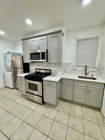 a kitchen with a sink and a stove top oven