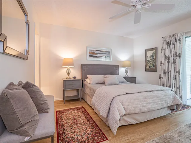 a bedroom with a bed and ceiling fan